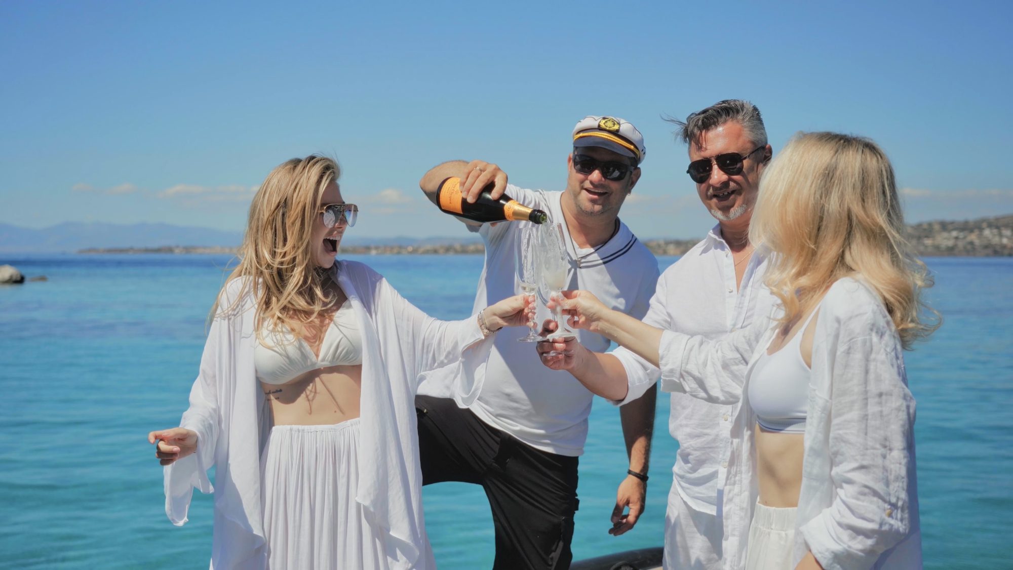 Champagne being poured for guests beside the sea